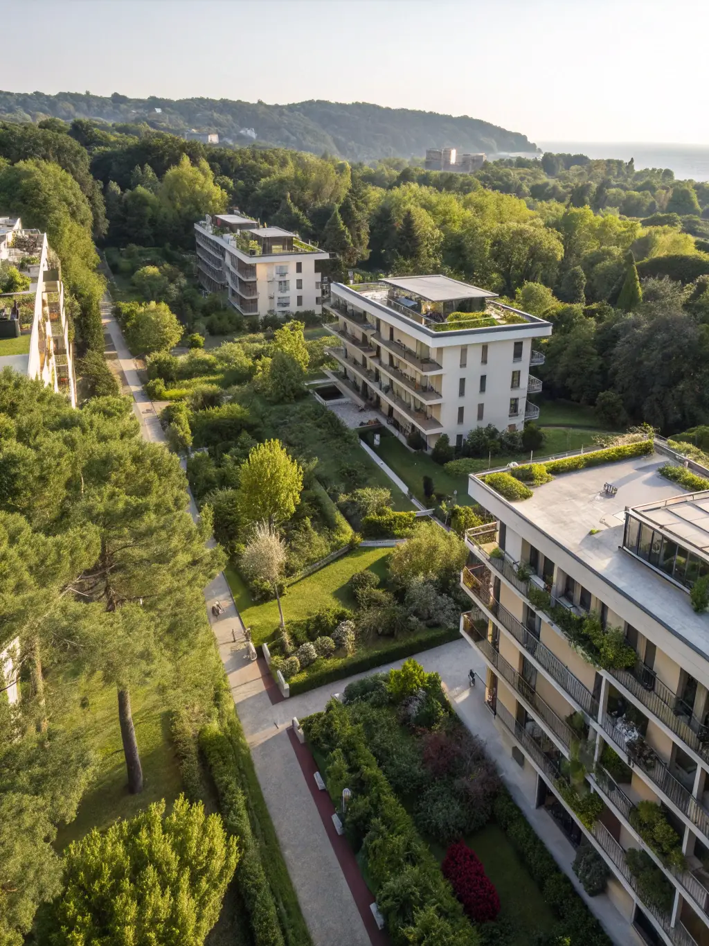 Mid-rise buildings with planted green roofs and trees along the street
